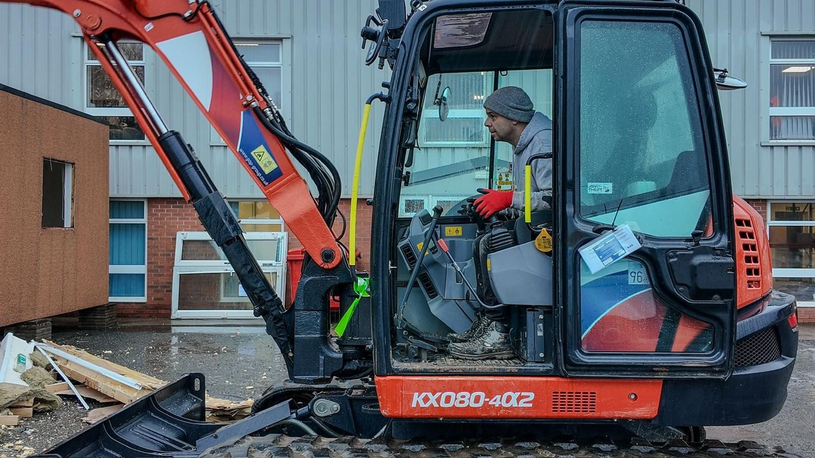 Excavator working at a commercial unit