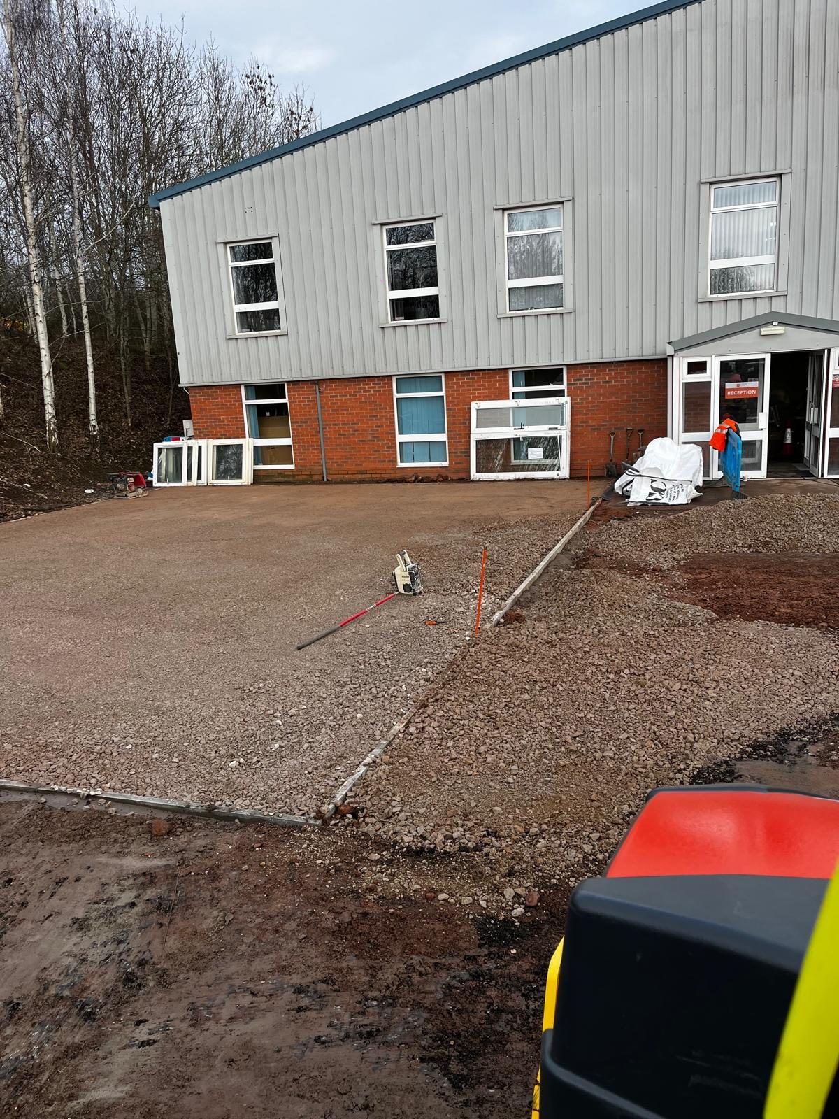 Stone sub-base spread over membrane at a commercial unit