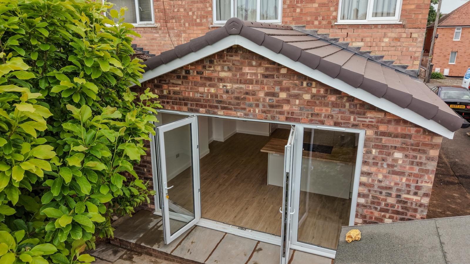 Completed single-storey brick extension with French doors