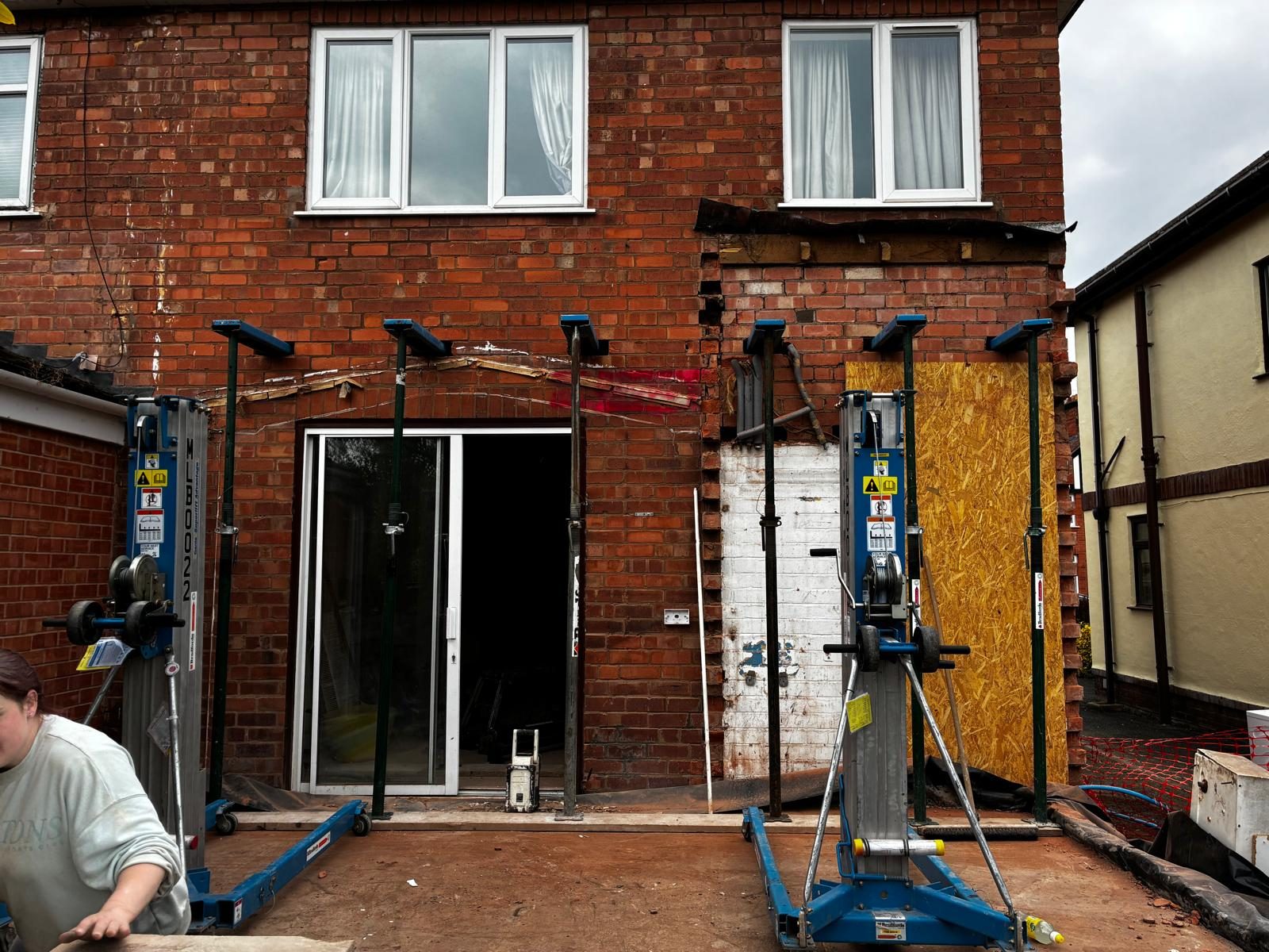 Steel props supporting a brick rear wall during removal