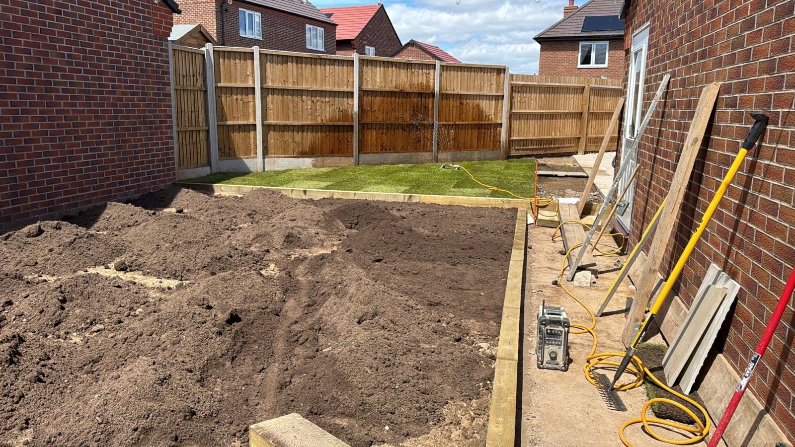 Timber sleeper edging installed in a garden under landscaping