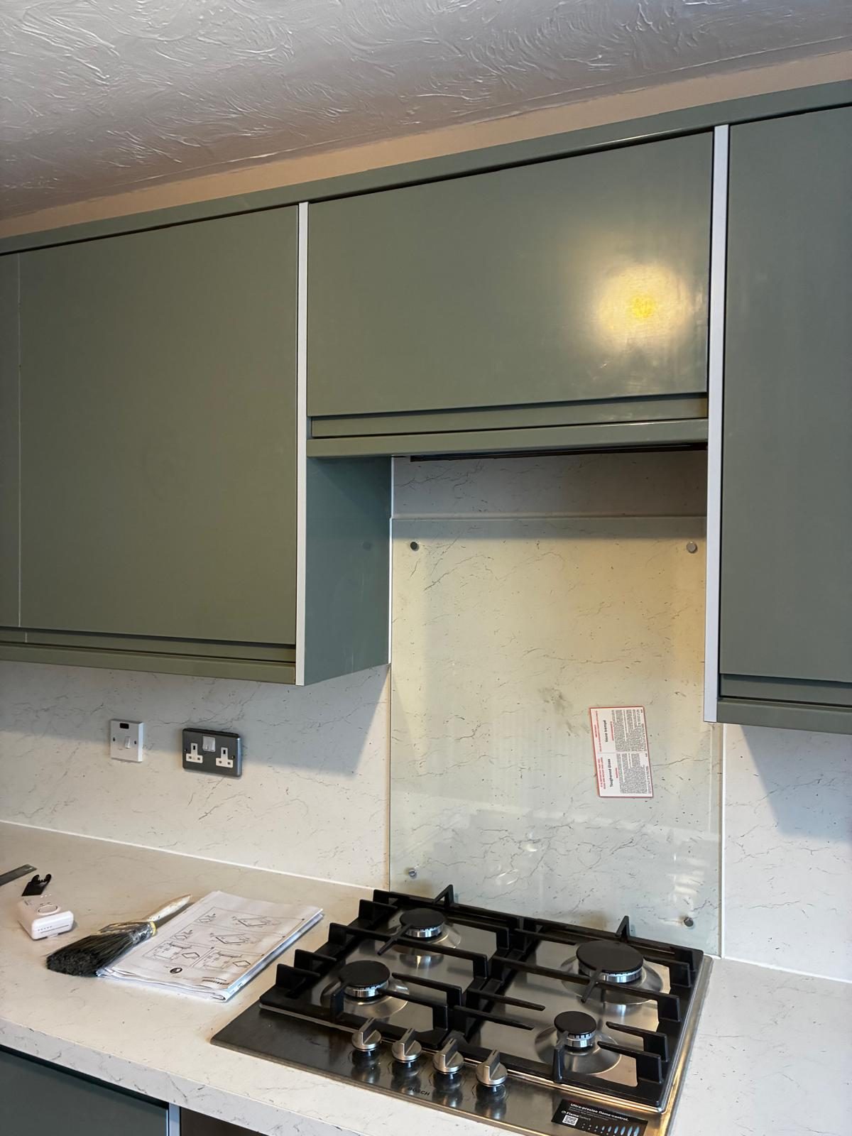 New gas hob and splashback in a refitted kitchen